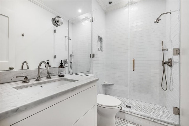 bathroom with tile patterned flooring, toilet, a shower with door, vanity, and ornamental molding