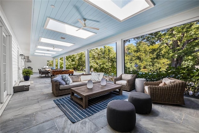 sunroom with a skylight and ceiling fan