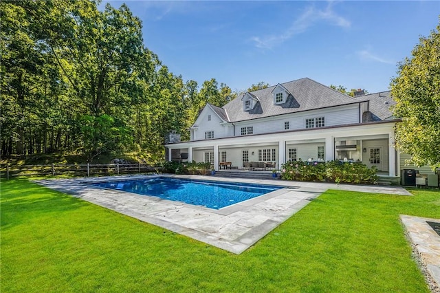 rear view of house featuring a lawn and a patio area