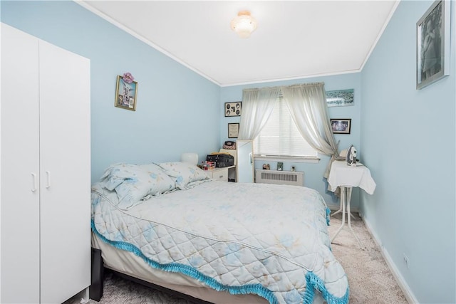 carpeted bedroom with radiator heating unit and ornamental molding