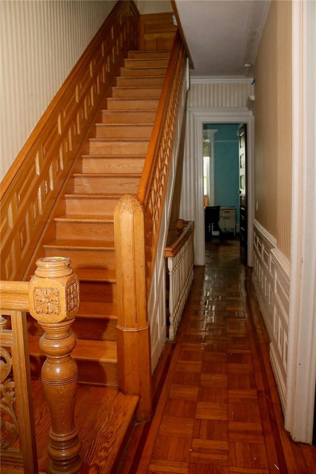 staircase featuring parquet floors