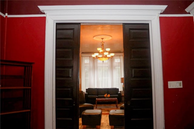 living area with ornamental molding and a notable chandelier