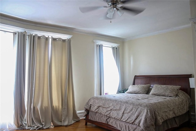 bedroom with ceiling fan, hardwood / wood-style flooring, and ornamental molding