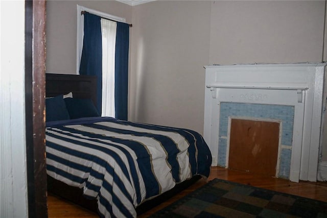 bedroom with dark hardwood / wood-style flooring