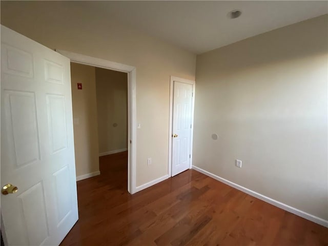 unfurnished bedroom featuring dark wood-type flooring