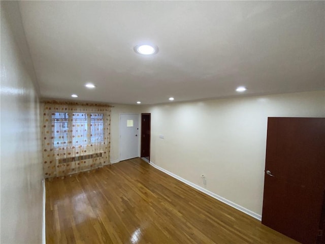 spare room featuring wood-type flooring