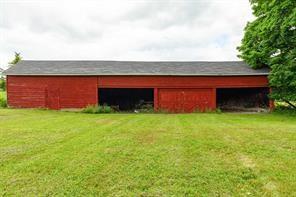 view of outdoor structure with a lawn