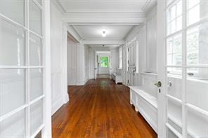 hallway with dark hardwood / wood-style flooring