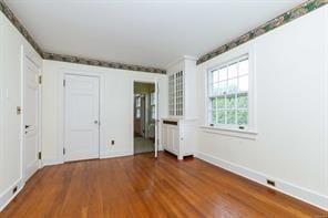 unfurnished bedroom featuring hardwood / wood-style flooring