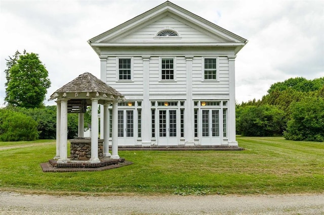 rear view of property with a lawn