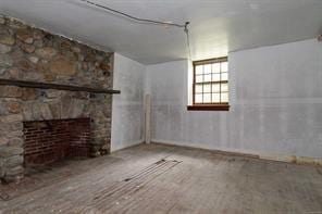 basement with a stone fireplace