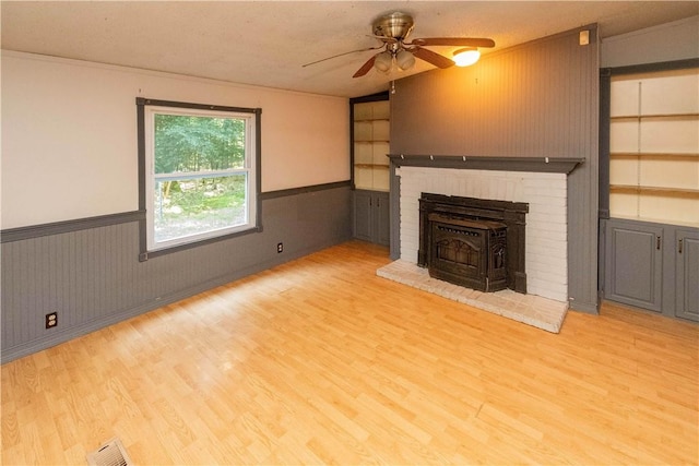 unfurnished living room with a textured ceiling, light hardwood / wood-style flooring, and ceiling fan