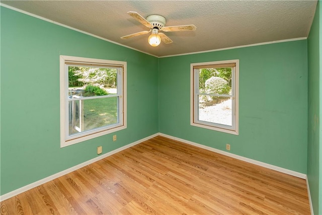 spare room featuring crown molding, vaulted ceiling, light hardwood / wood-style flooring, ceiling fan, and a textured ceiling