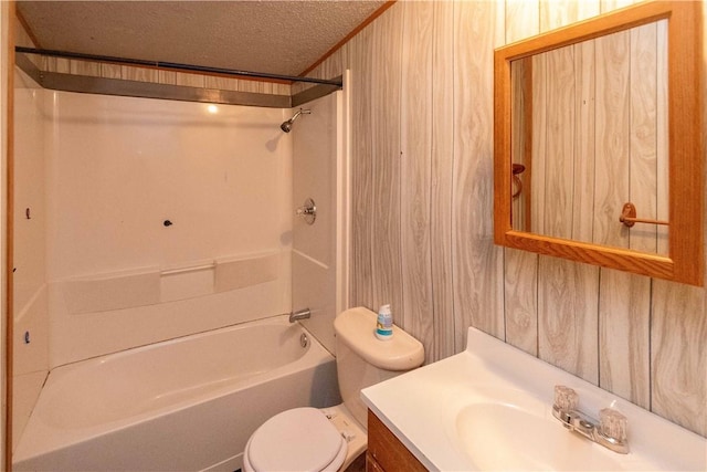 full bathroom with vanity, wood walls, toilet, a textured ceiling, and shower / bath combination