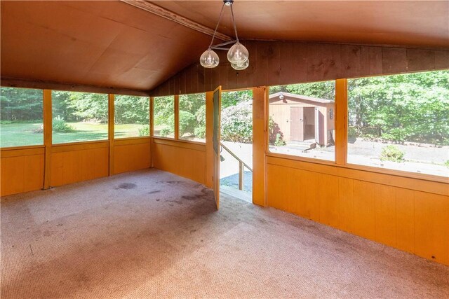 unfurnished sunroom with plenty of natural light and lofted ceiling