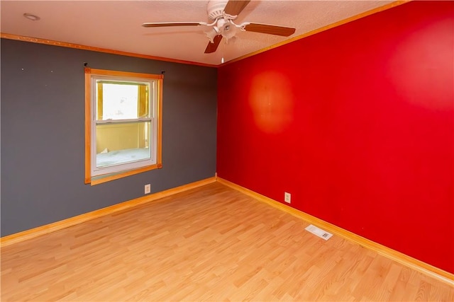 spare room with hardwood / wood-style floors, ceiling fan, and crown molding