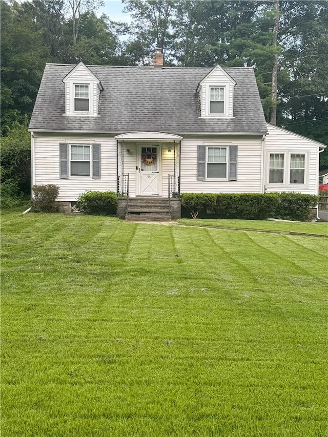 cape cod house with a front lawn