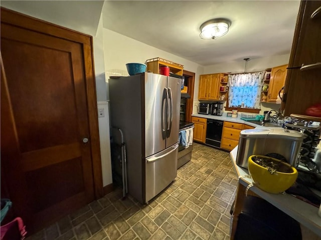 kitchen featuring pendant lighting, stainless steel appliances, and sink