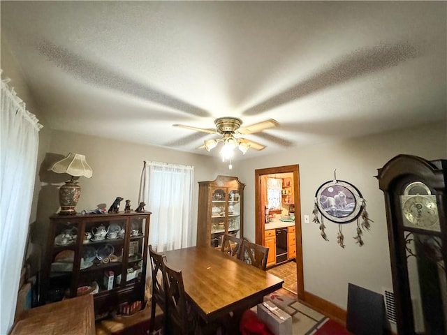 tiled dining room featuring ceiling fan and a textured ceiling