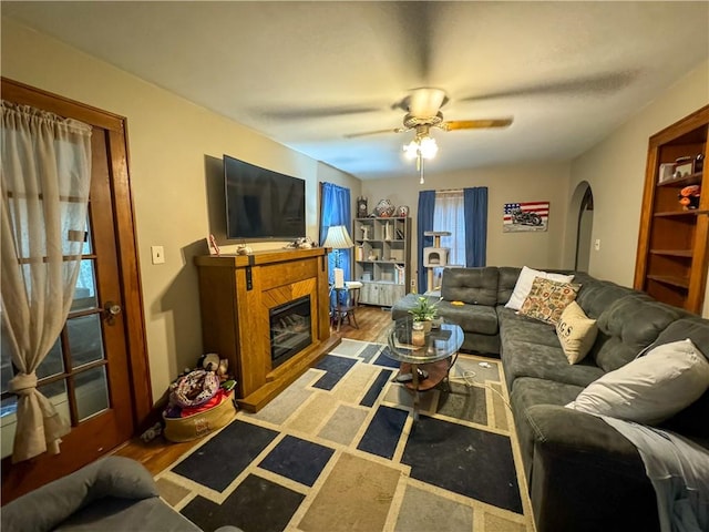 living room featuring hardwood / wood-style floors, ceiling fan, and a healthy amount of sunlight