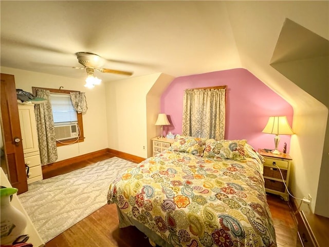 bedroom with ceiling fan, hardwood / wood-style floors, cooling unit, and lofted ceiling