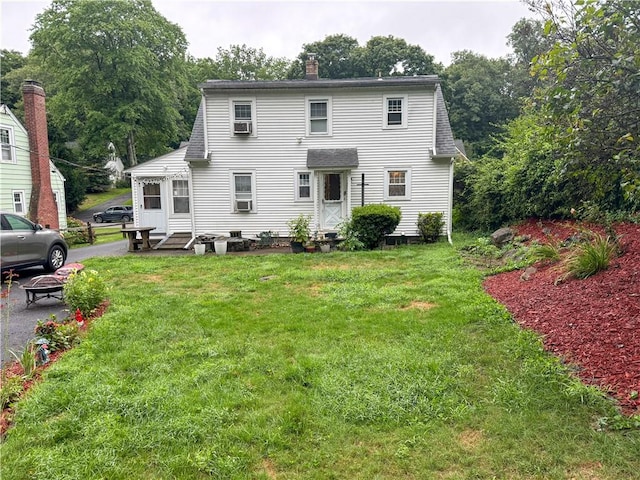 rear view of property with a yard