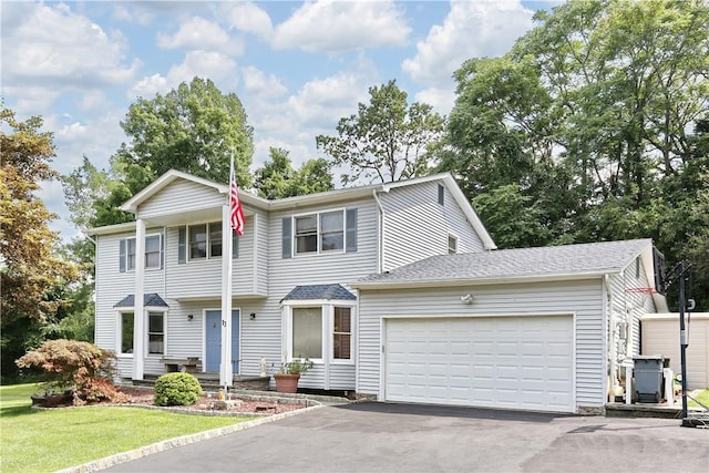 view of front facade featuring a garage and a front lawn