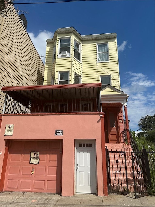 view of front of house featuring cooling unit and a garage