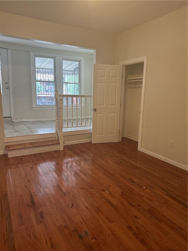 unfurnished bedroom with hardwood / wood-style floors and a closet