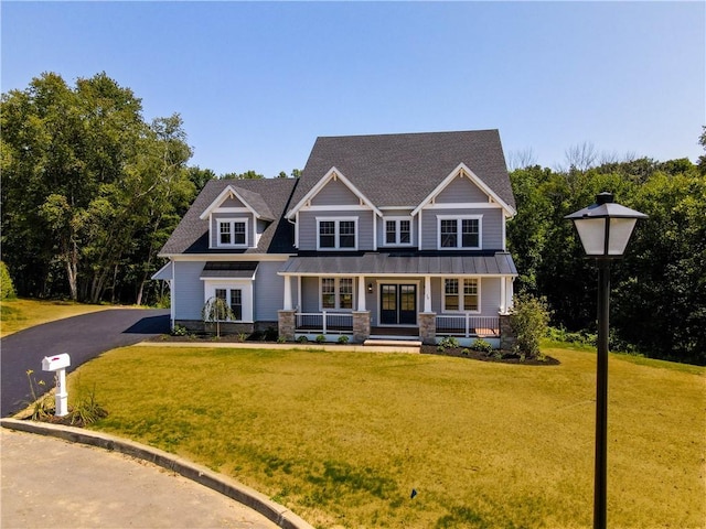 craftsman house with a porch and a front lawn