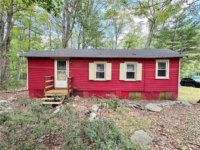 view of front of property featuring roof with shingles and crawl space