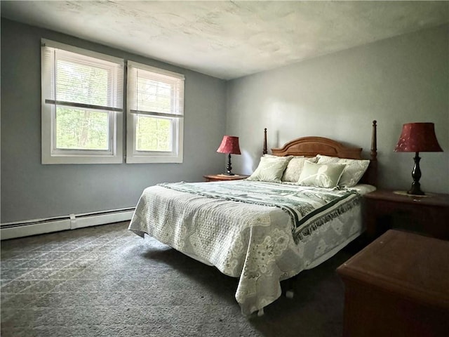 bedroom featuring dark carpet and a baseboard heating unit