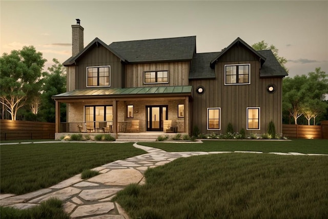 view of front of house featuring a porch and a yard