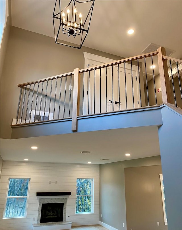 stairs with a towering ceiling and a chandelier