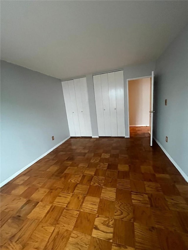 unfurnished bedroom with two closets