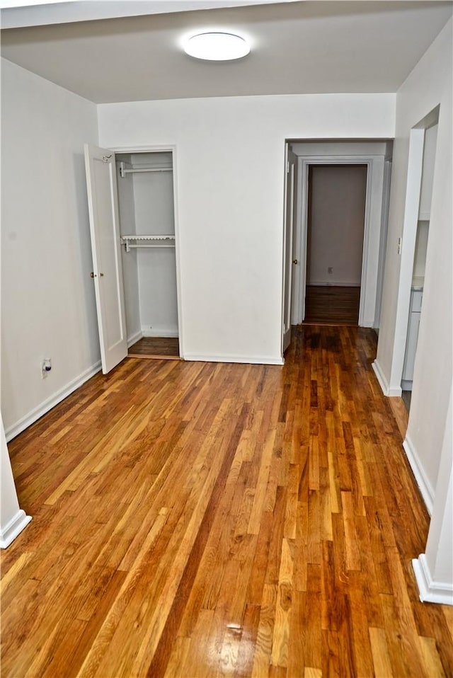 unfurnished bedroom featuring a closet and wood-type flooring