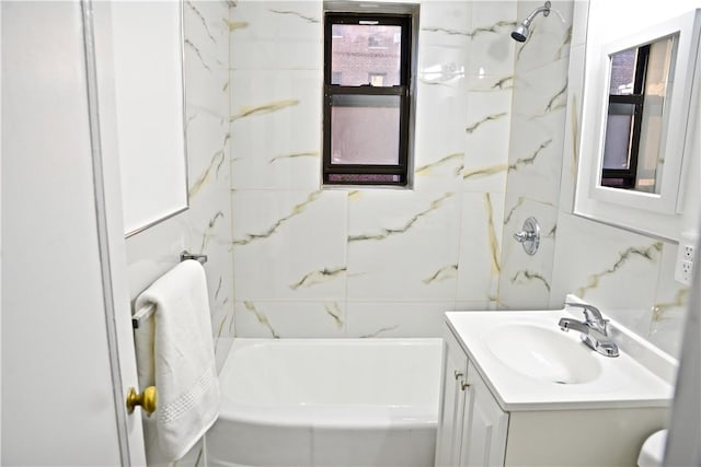 bathroom with vanity and tiled shower / bath combo