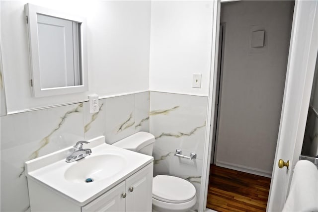 bathroom featuring vanity, wood-type flooring, and toilet