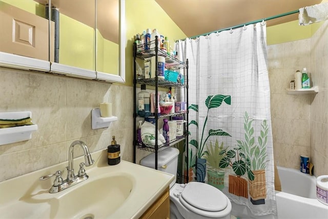 full bathroom with shower / bath combo with shower curtain, vanity, tile walls, and toilet