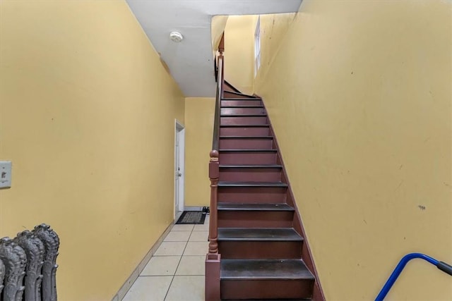 staircase with tile patterned floors