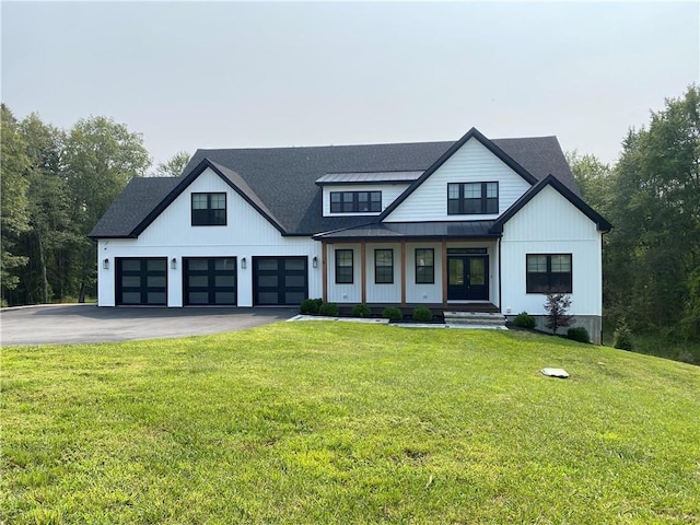 modern farmhouse with a front lawn and covered porch