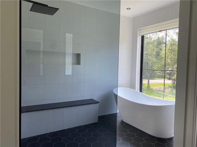 bathroom with tile patterned floors, separate shower and tub, ornamental molding, and tile walls