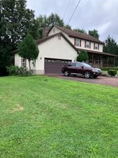 view of front of property with a garage and a front yard