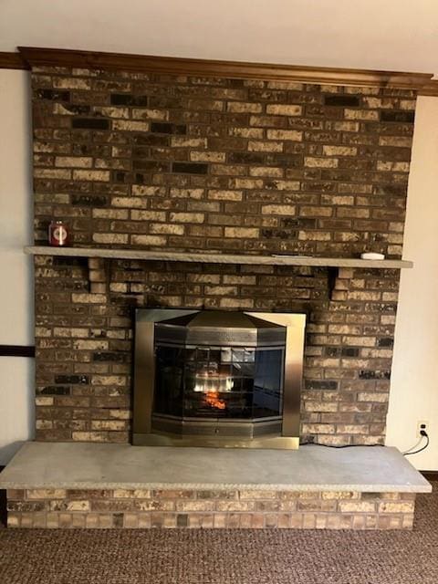 room details with carpet flooring, a fireplace, and ornamental molding