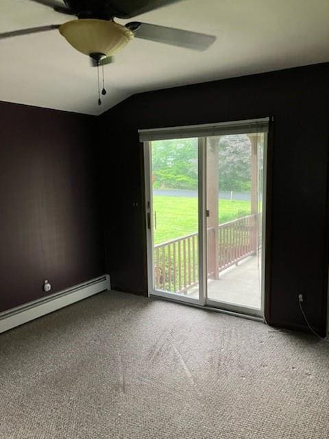 empty room with lofted ceiling, carpet floors, and a baseboard heating unit