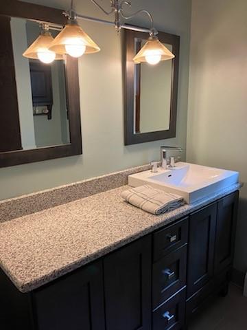 bathroom with vanity and an inviting chandelier