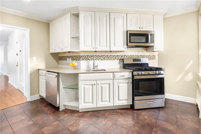 kitchen featuring backsplash, white cabinets, crown molding, sink, and stainless steel appliances