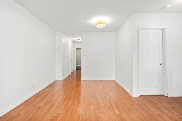 empty room with light hardwood / wood-style flooring