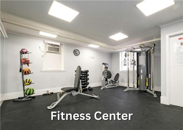 workout area with an AC wall unit and crown molding