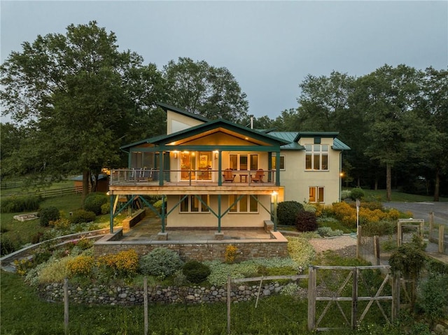 rear view of property with a patio and a wooden deck